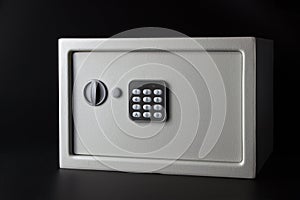 Modern light money bank safe on a black background with a coded lock photo