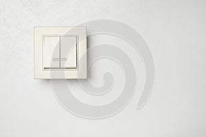 Modern light switch on white background. Space for text