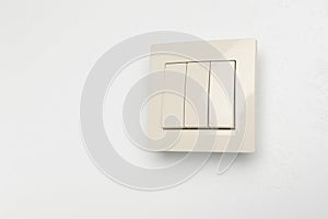 Modern light switch on white background. Space for text
