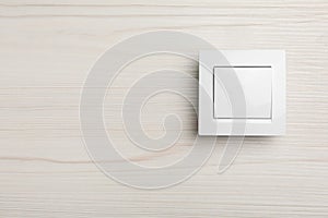 Modern light switch on white background. Space for text