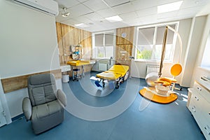 Modern light ward of maternity hospital. Empty patient beds in a maternity ward.