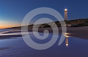 Modern lighthouse at night photo