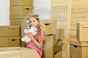 Modern Living in the Heart of the City. happy child cardboard box. happy little girl with toy. Moving concept. new