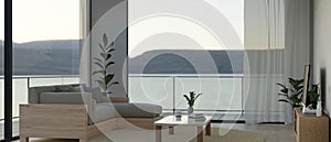 Modern living room with couch, coffee table, smart TV, large glass window with nature view, balcony