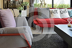 Modern living room design with pillows on the red sofa and decor