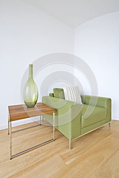 Modern living room detail with green armchair