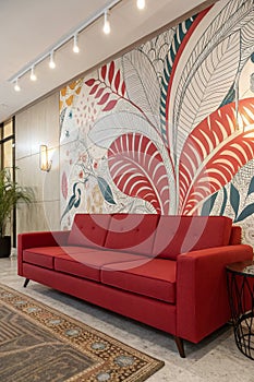 Modern red sofa with abstract wallpaper photo