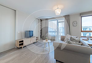 Modern Living Room Interior with Open TV Area and TV on the Wooden Desk, Sofa, And Coffee Table