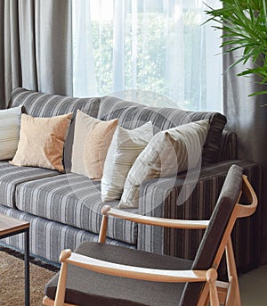 Modern living room interior with striped pillows on a casual sofa