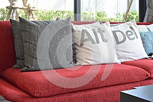 Modern living room with pillows on the red sofa