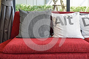 Modern living room with pillows on the red sofa and decor