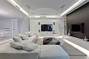 a modern living room with a state-of-the-art home entertainment system, high tech lighting, and contemporary furniture
