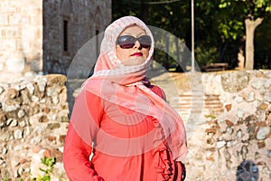 Modern Lookalike Muslim Woman With Scarf and Sunglasses Posing in Front of the Mosque