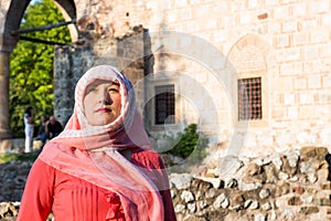 Modern Lookalike Muslim Woman With Scarf and Sunglasses Posing in Front of the Mosque