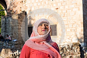 Modern Lookalike Muslim Woman With Scarf and Sunglasses Posing in Front of the Mosque