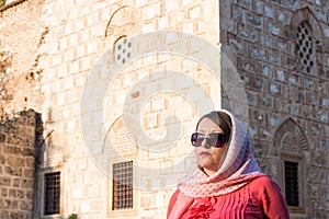 Modern Lookalike Muslim Woman With Scarf and Sunglasses Posing in Front of the Mosque