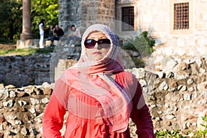 Modern Lookalike Muslim Woman With Scarf and Sunglasses Posing in Front of the Mosque