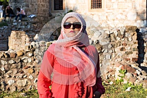 Modern Lookalike Muslim Woman With Scarf and Sunglasses Posing in Front of the Mosque