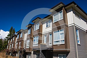 Modern low rise wood frame complex. Brand new apartment building on sunny day in spring.