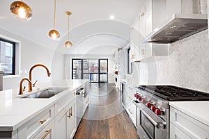 A modern luxurious kitchen with white and black cabinets.