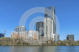 Modern luxury apartments towering against blue sky with Colorado River view