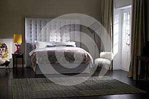 Modern luxury bedroom interior in pastel colors with king size bed.