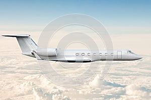 Modern luxury business jet flies in the air above the clouds