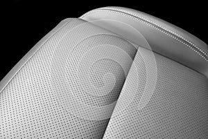 Modern luxury car black leather interior. Part of black leather car seat details with white stitching. Interior of prestige car.