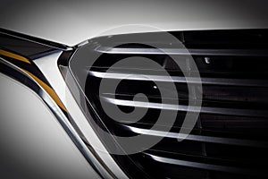 Modern luxury car close-up of grille. Expensive, sports auto detailing
