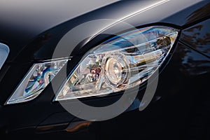 Modern luxury car headlights closeup.