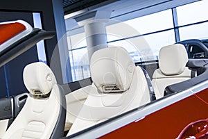 Modern Luxury car inside. Interior of prestige modern cabriolet car. Comfortable leather seats. White perforated leather. Modern