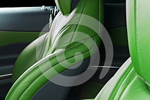 Modern Luxury car inside. Interior of prestige modern car. Comfortable leather red seats. Green perforated leather. Modern car