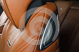 Modern Luxury car inside. Interior of prestige modern car. Comfortable leather red seats. Orange perforated leather. Modern car