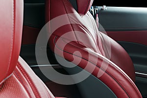 Modern Luxury car inside. Interior of prestige modern car. Comfortable leather red seats. Red perforated leather. Modern car
