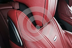 Modern Luxury car inside. Interior of prestige modern car. Comfortable leather red seats. Red perforated leather. Modern car