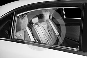 Modern Luxury car inside. Interior of prestige modern car. Comfortable leather seats. Black perforated leather. Back passenger sea
