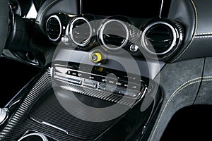 Modern Luxury car inside. Interior of prestige modern car. Comfortable leather seats. Black perforated leather with yellow