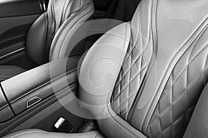 Modern Luxury car inside. Interior of prestige modern car. Comfortable leather seats. Perforated leather with isolated Black backg