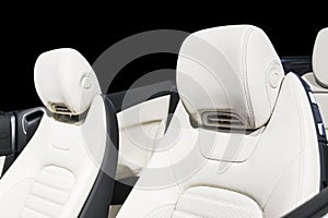 Modern Luxury car inside. Interior of prestige modern car. Comfortable leather seats. White perforated leather cockpit
