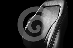 Modern luxury car leather interior. Part of leather car seat details with white stitching. Interior of prestige car. Comfortable p