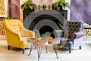 Modern luxury home and living room, fireplace and and armchairs.colorful wall decoration, wooden creative table. Living