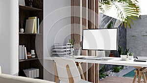 Modern luxury home office interior design with computer mockup and office supplies on the table
