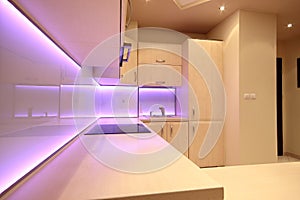 Modern luxury kitchen with pink LED lighting