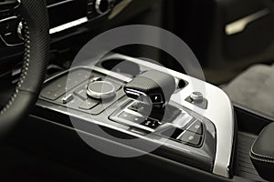 Modern luxury prestige car interior, gearbox, steering wheel. Black leather