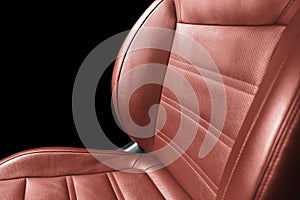 Modern luxury red leather interior. Part of red leather car seat details with stitching. Interior of prestige car. Comfortable red