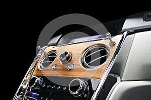 Modern Luxury sport car inside. Interior of prestige vehicle with natural wood panel. White Leather with stitching. Car detailing.
