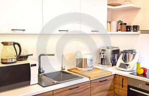 Modern machines (equipment) are in the kitchen interior. Automatic food processors culinary robots, coffee machine and