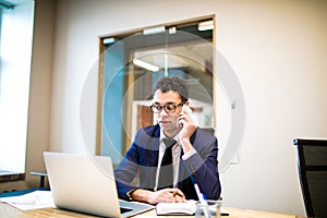 Modern male entrepreneur calling via cellphone