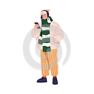 Modern man in winter clothes, holding mobile phone in hand. Young stylish guy with smartphone, wearing fashion apparel