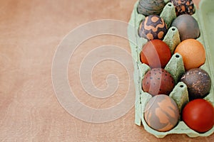 Modern marble, brown and red easter eggs painted with organic onion and carcade tea. Zero waste holiday. Stylish Easter eggs